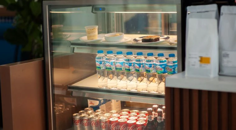 Chilled drinks and desserts in a cafe refrigerator, providing a refreshing selection