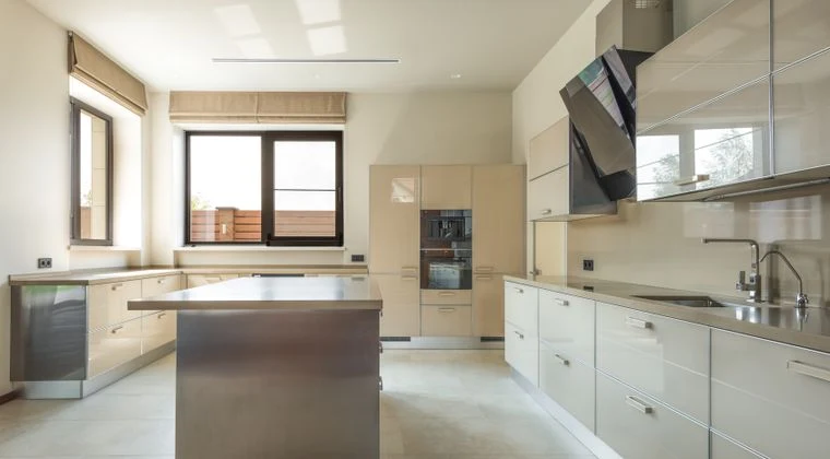 Bright and spacious modern kitchen interior featuring sleek cabinets and a central kitchen island